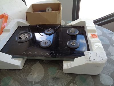a box on top of a stove that is sitting on a table