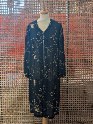a mannequin mannequin dress on display in front of a screen