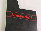 a close up of a nintendo logo on a black card