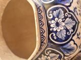 a blue and white vase sitting on a table