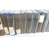 books are lined up in a row on a white surface