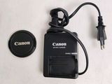 a canon battery charger and a charger on a table