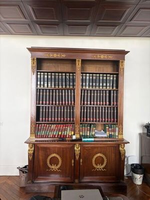 a large bookcase with many books on it in a living room