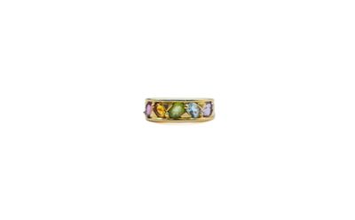 a close up of a gold ring with multi colored stones