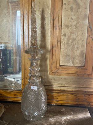 a glass vase sitting on a table next to a mirror