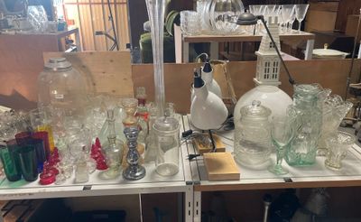 a lot of bottles and glasses on a shelf