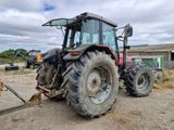 a tractor that is parked in the dirt