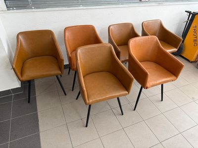 four chairs sitting in a row in a waiting room