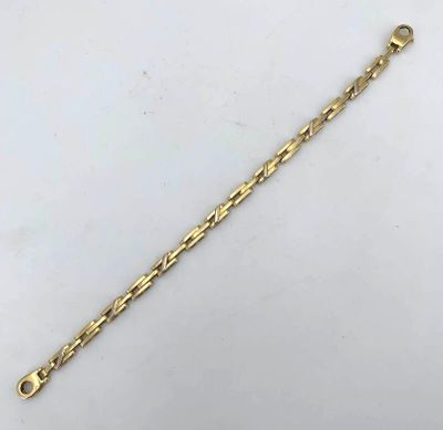 a gold bracelet with a long chain and a clasp
