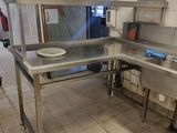 a kitchen with a sink and a counter with a plate on it