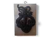 a picture of a wall mounted sculpture of a man and a woman