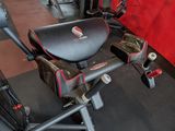a gym room with a stationary exercise bike and treads