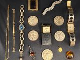 a lot of gold and silver jewelry on a black table