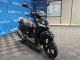 a scooter that is parked in front of a blue wall