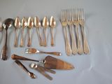 a lot of silver spoons and forks on the table