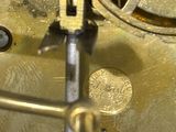 a close up of a clock that is on a table