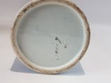 a white bowl with a brown rim sitting on a white surface