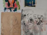 many drawings and pictures on the wall of this room