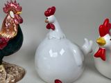 three ceramic chickens that are standing next to each other
