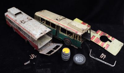 a small toy bus that is sitting on a black surface