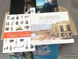 several books are stacked on top of each other on a table