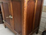 a wooden cabinet with a door on the side of it