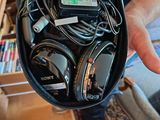 a person holding a bag full of headphones and cords