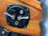a close up of a wooden seat with a key on it