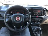 dashboard of a small car with a steering wheel and dashboard controls