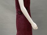 a close up of a mannequin wearing a red dress on a mannequin stand