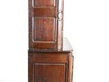 an image of a tall wooden cabinet with a door on top of it