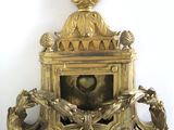 a gold clock with a bird on top of it
