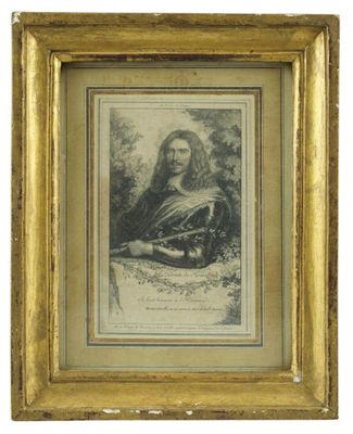 une vieille photo d'un homme barbu dans un cadre en or
