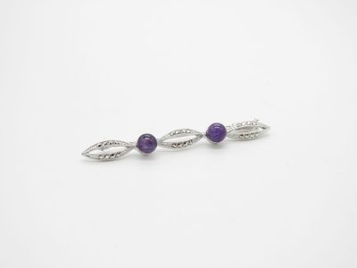 a pair of silver and amethtite earrings with purple stones