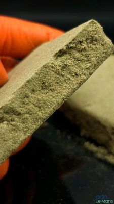 a person holding a piece of cement in their hand