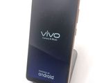 a phone that is sitting on a stand on a table