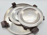 two silver plates sitting on top of each other on a table