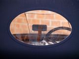 a reflection of a car in a mirror on the side of the road