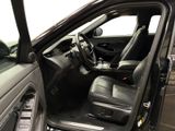the interior of a car with the door open and the driver ' s seat down