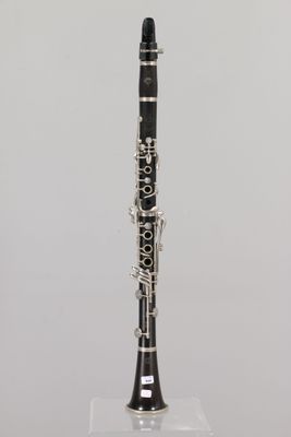 a close up of a clarinet on a stand with a white background