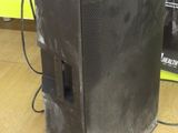 a speaker that is sitting on the floor next to a wall