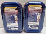 two bottles of blue liquid sitting next to each other on a white surface