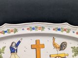 a plate with a picture of a woman and a cross on it