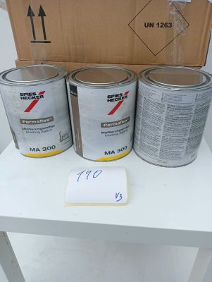 three cans of paint sitting on a table next to a cardboard box