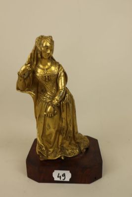 brass figurine of a woman holding a basket of flowers on a wooden base