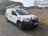 a white van with red and white stripes parked on the side of the road
