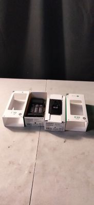 trois téléphones portables qui sont rangés dans des boîtes sur une table