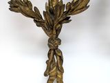 an image of a gold candle holder with a bird on it