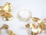 a lot of gold jewelry on a white surface