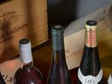 several bottles of wine are lined up in a row on a table